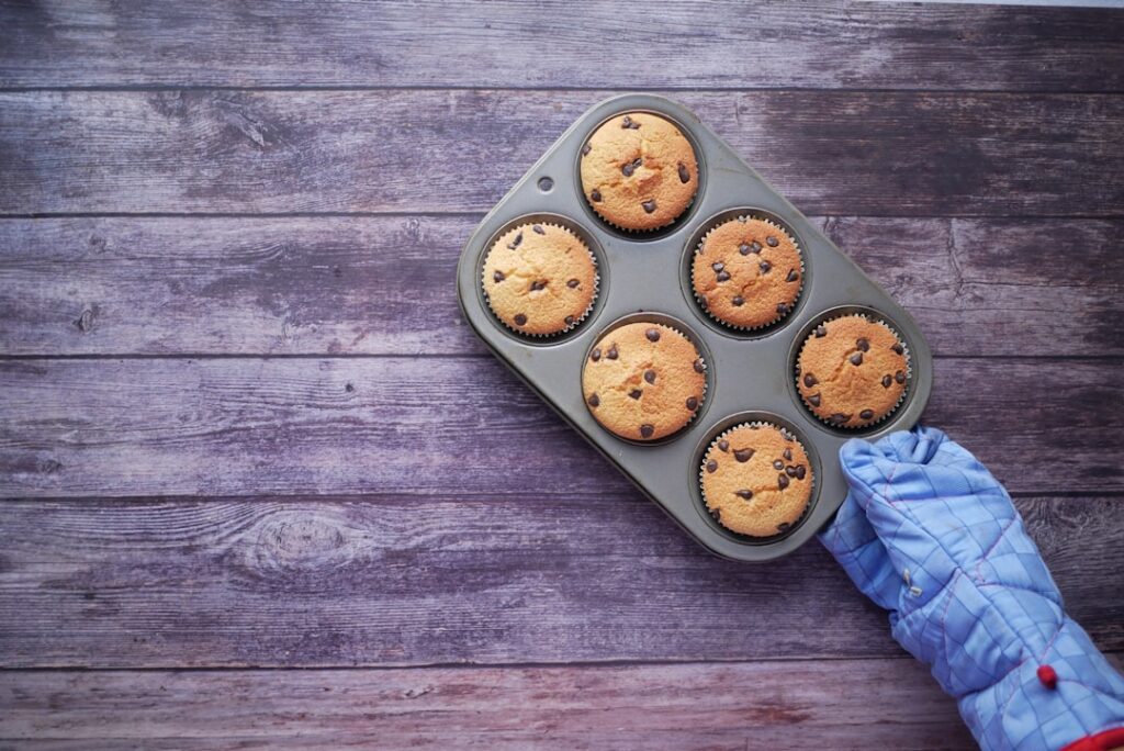 Freshly baked chocolate chip cookies cooling on a wire rack with a mountain view, illustrating successful baking above 7000 feet.