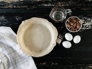 Golden brown, flaky high altitude pie crust cooling on a wire rack, showcasing its perfect texture.