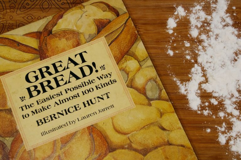 Hands kneading perfectly risen dough at high altitude, demonstrating successful yeast adjustment for baking.